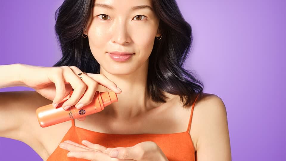 Model applying The Brightening Eye Cream