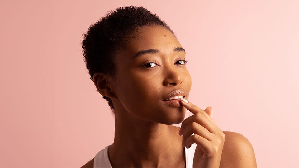 Model applying The Kissu Lip Scrub