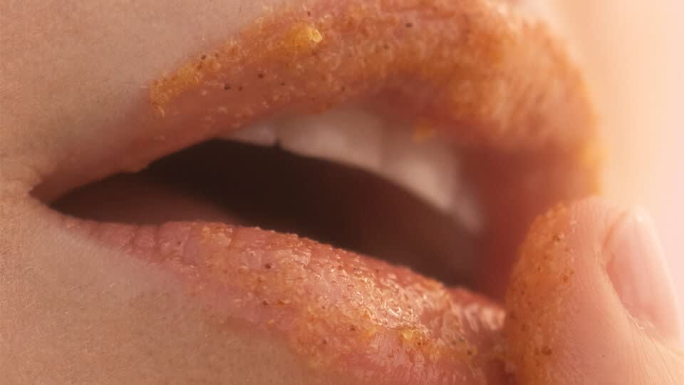 The Kissu Lip Scrub being used on lips