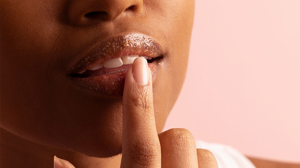 Model applying The Kissu Lip Scrub
