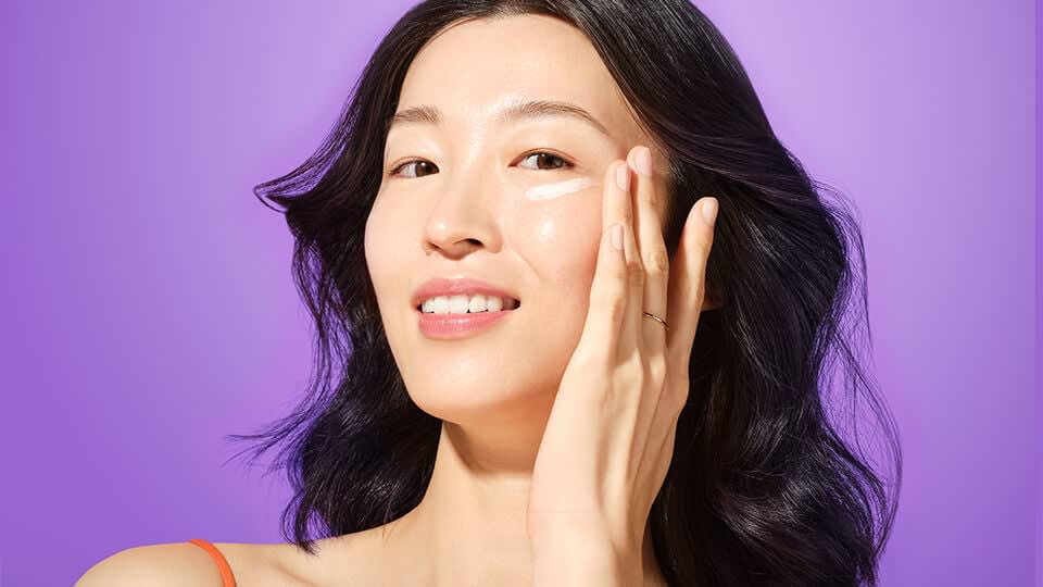 Model applying The Brightening Eye Cream