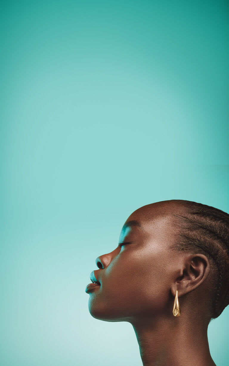 Side profile view of model with a glowing green background.