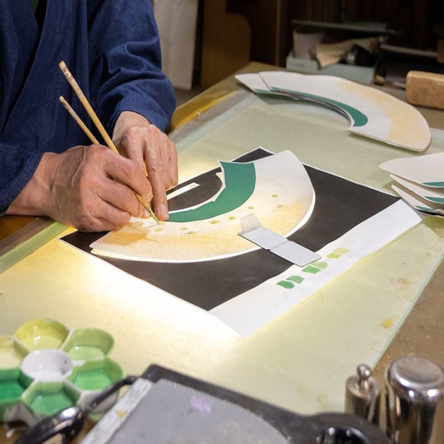 Artisan handcrafting a fan.