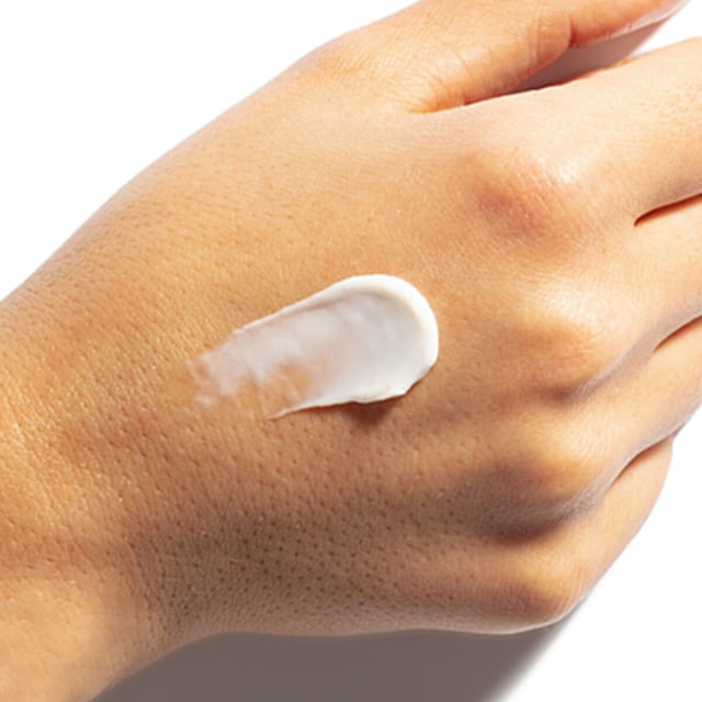 Shot of Ageless Revitalizing Neck Cream on hand.
