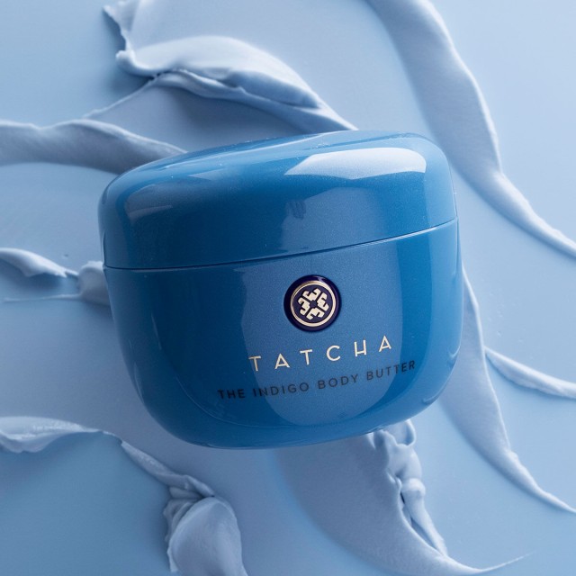 Shot of Indigo Body Butter without cap beside product texture.