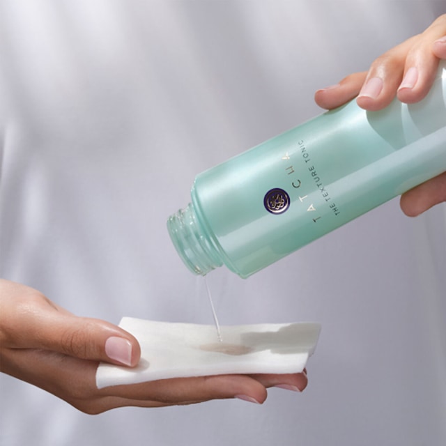 Pouring The Texture Tonic onto our Organic Cotton Pads for application.