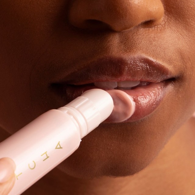 Woman applying lip product