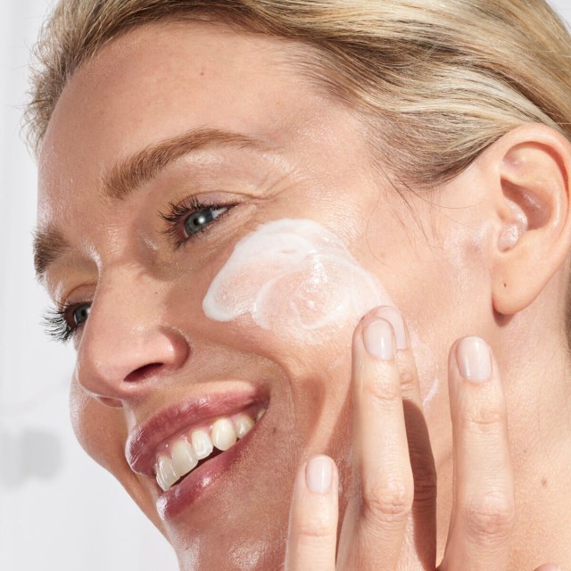 woman applying Tatcha Silk cream to face