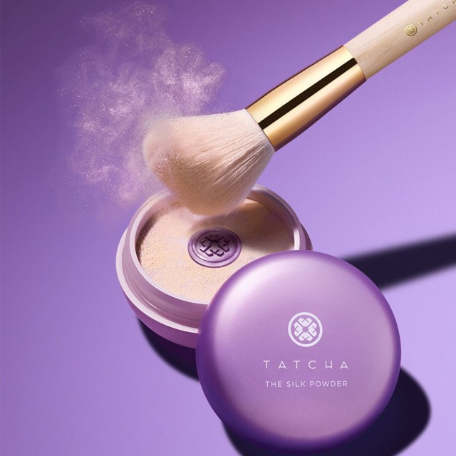 Shot of The Powder Brush lightly dusting The Silk Powder for application.