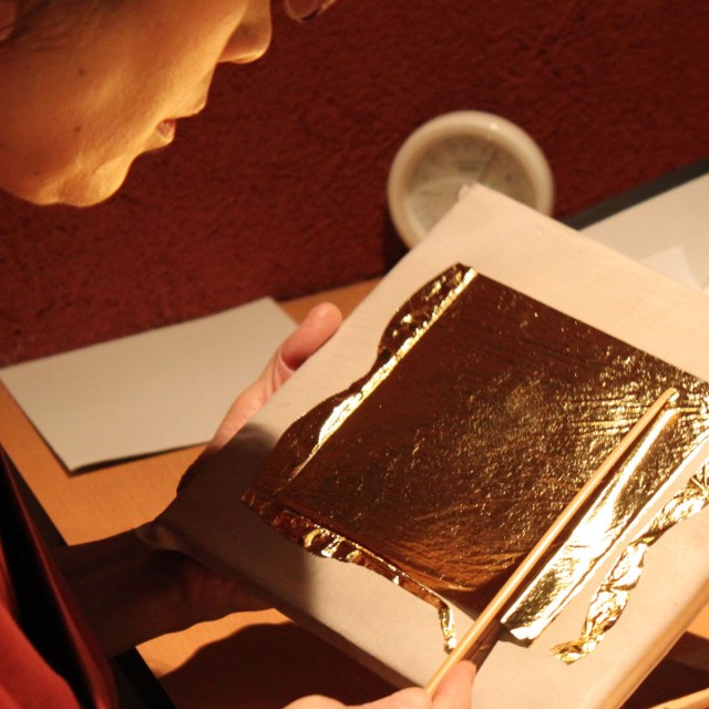 Craftman working with gold foil